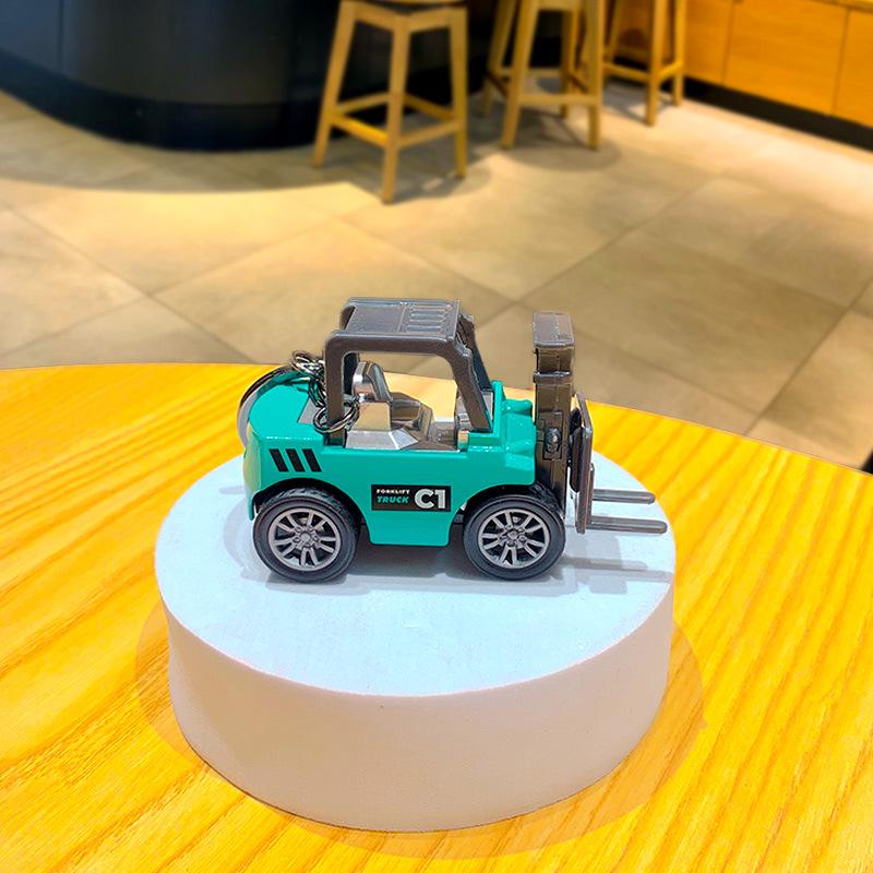 Creative Cartoon Mini Excavator Keychain Toy - Perfect for Backpacks or Car Pendants.