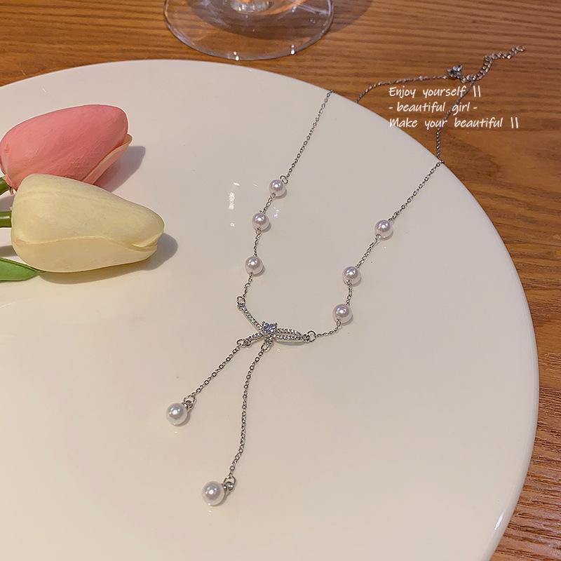 

Элегантное титановое ожерелье с бантом и жемчужной кисточкой