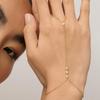 Stylish 18k Gold-Plated Titanium Bracelet with Diamond-Studded Bead & Finger Chain