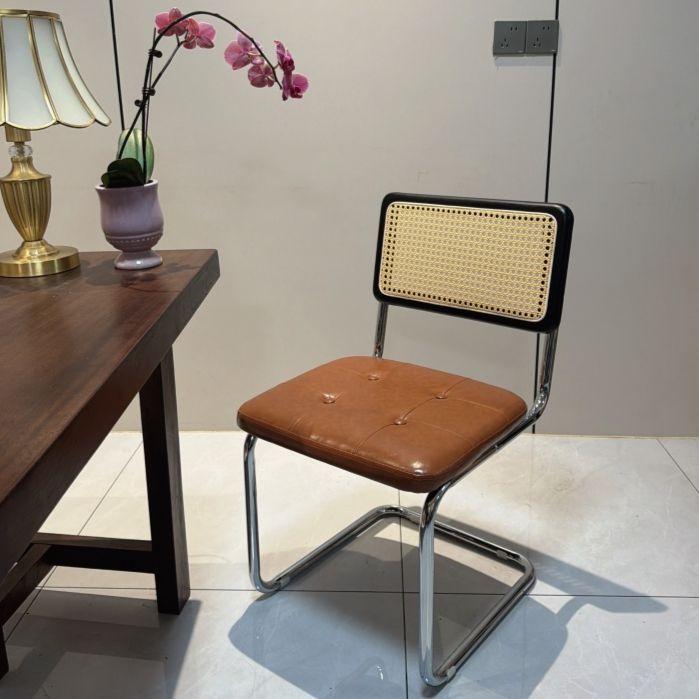 Elegantly crafted armless rattan dining chair in retro pastoral style, perfect for cafes, guesthouses, and vintage settings.