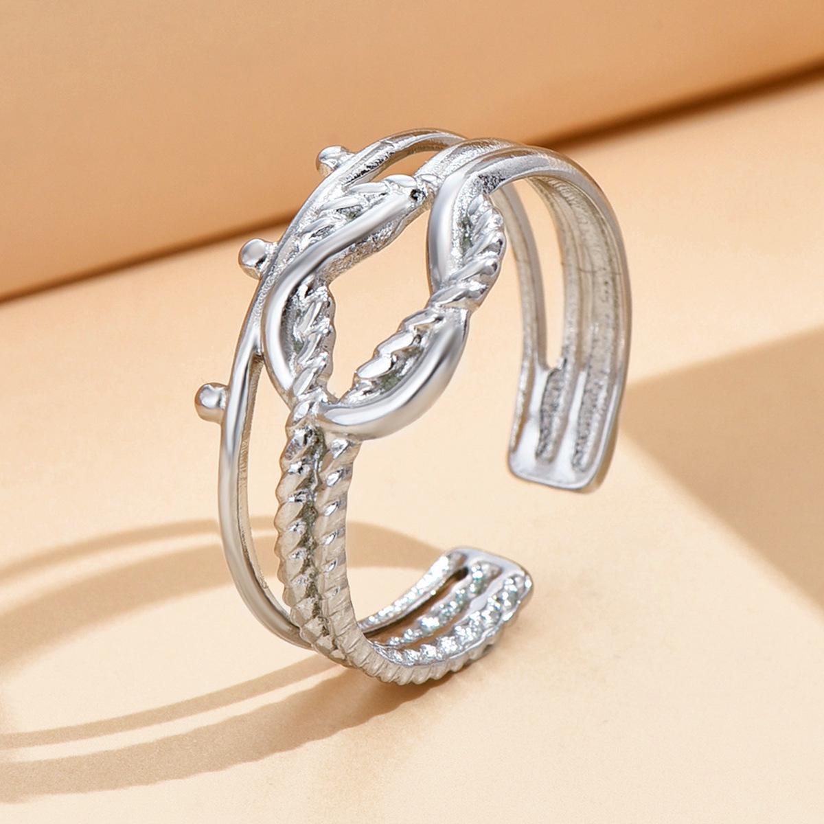 European-American Eternal Knot Ring: Women s Retro Geometric Openwork Twist Finger Ring in Titanium Steel.