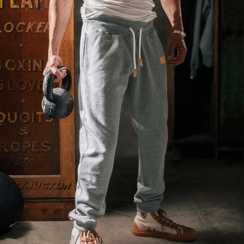 Neue Europäische und Amerikanische Herren Frühling und Herbst Lässige Sporthosen Herren Locker Kordelzug Einfarbige Schmal zulaufende Trendige Jogginghosen Lagerware