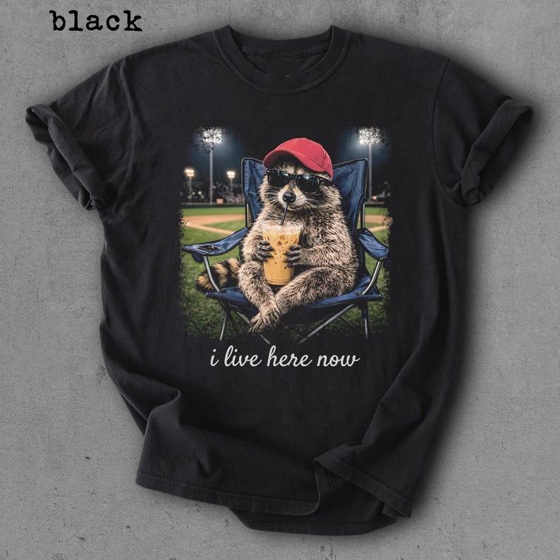 

Raccoon I live Here Now Shirt Raccoon Drinking Iced Coffee Shirt Full Size S3XL Unisex T-Shirt XXXXL