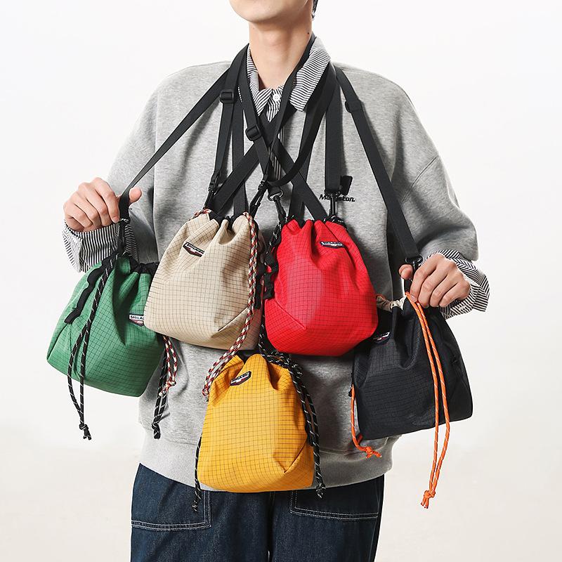 Trendy brand personalized messenger bag, drawstring bundle, versatile mobile phone bag, lightweight sports bucket bag, casual shoulder bag.