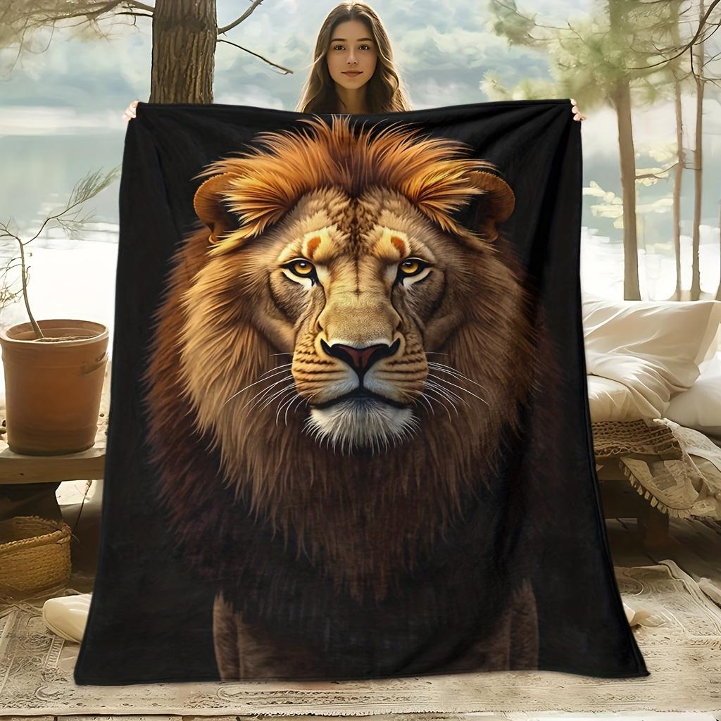 Eine kuschelige Fleecedecke mit Löwenmotiv, mit weichem, hochauflösendem Digitaldruck auf schwarzem Hintergrund und goldener Mähne, perfekt zum Kühlen bei