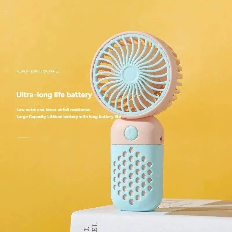 Handventilator mit Ladefunktion, Cartoon-Design, kleiner Ventilator für Schüler, der kleinen Ventilator auflädt, tragbarer Mini-Taschen-USB-V