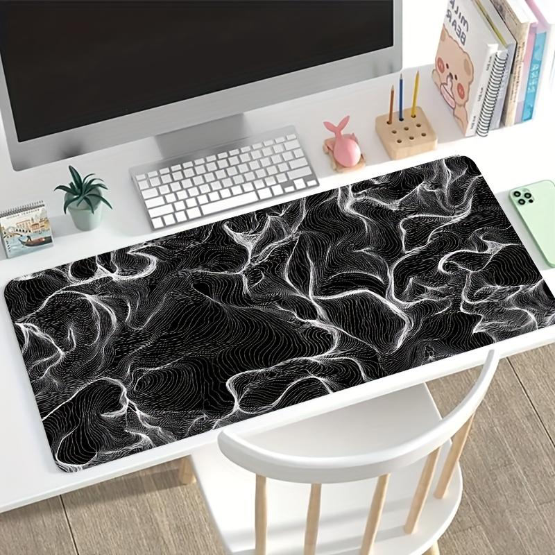 A Large Electronic Sports Gaming Mouse Pad Featuring an Abstract Design with Flowing Black And White Lines