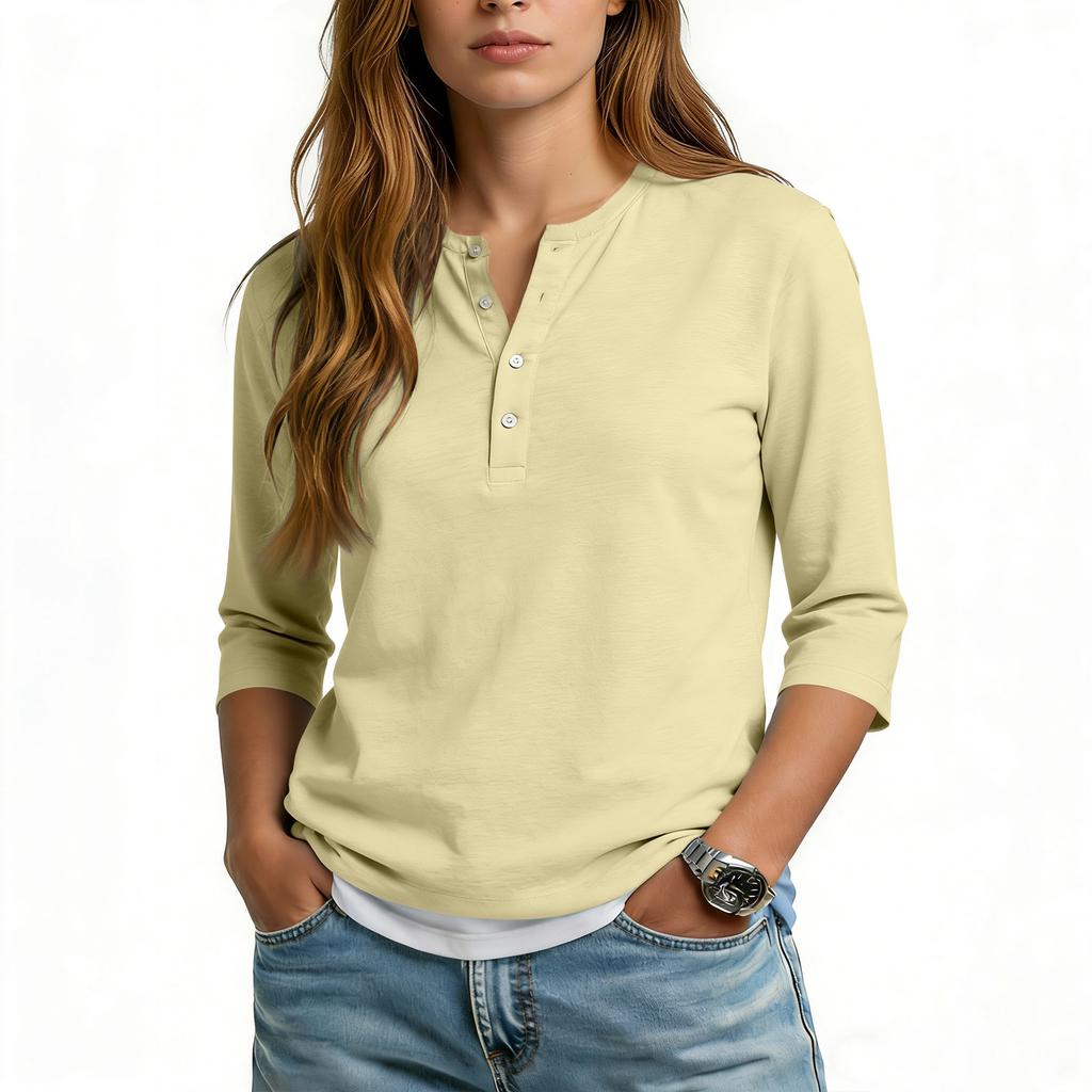 Camiseta informal de mujer con cuello en V, manga tres cuartos y botones decorativos.