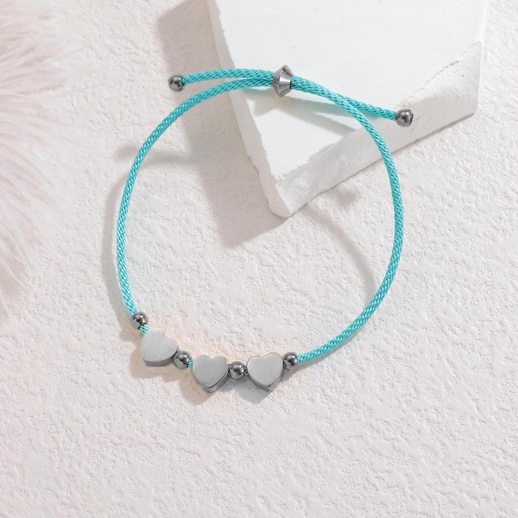 Minimalistisches blaues Seilarmband mit Herz-, Männchen- und runden Anhängern aus Edelstahl