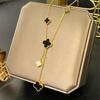 European & American Trendy Hollow Four-Leaf Clover Necklace with Black Shell Tassel Pendant.