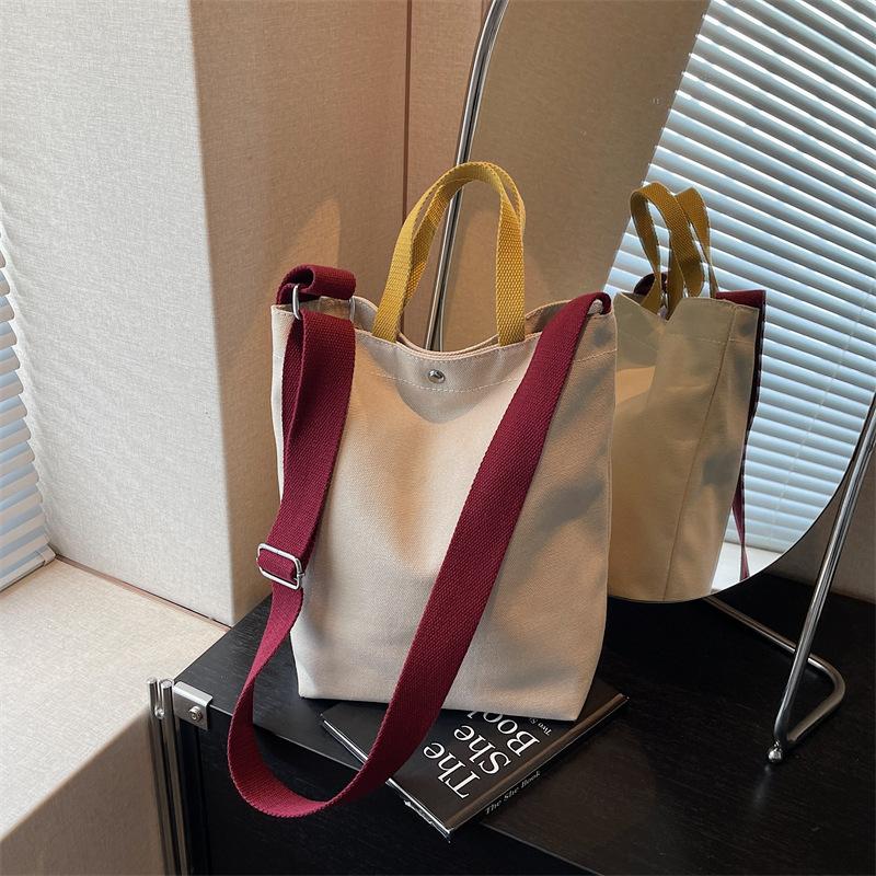 Portable shoulder tote cloth bag women's new simple commuting design sense niche large-capacity leisure bucket bag