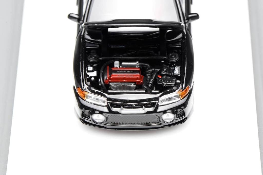 FREESTYLE MOTORHELIX Mitsubishi Lancer Evolution IV Pyrenees Black Pearl Finished Model M64004 1/64