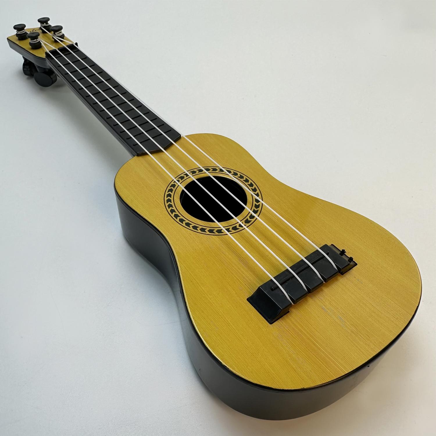 

Music-Orientated Children S Guitar Plaything That Can Be Played With A Pick To Imitate Basic Musical Instruments, Resembling A Ukulele