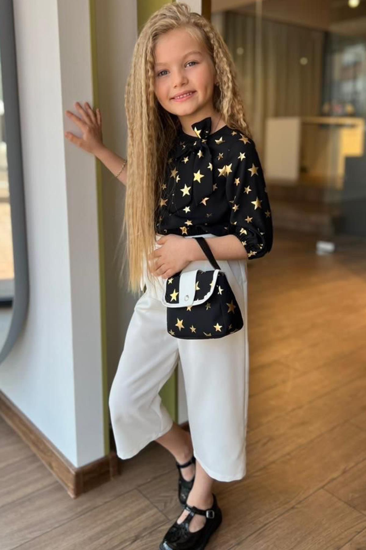 

Комплект из эластичных черных низа и верха с эластичной резинкой на щиколотке и талии для девочек с узором в виде звезд