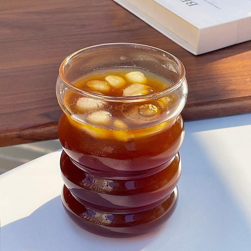 

Transparent Heat-Resistant Borosilicate Glass Cup, Single-Layer Caterpillar Design for Juice or Milk.