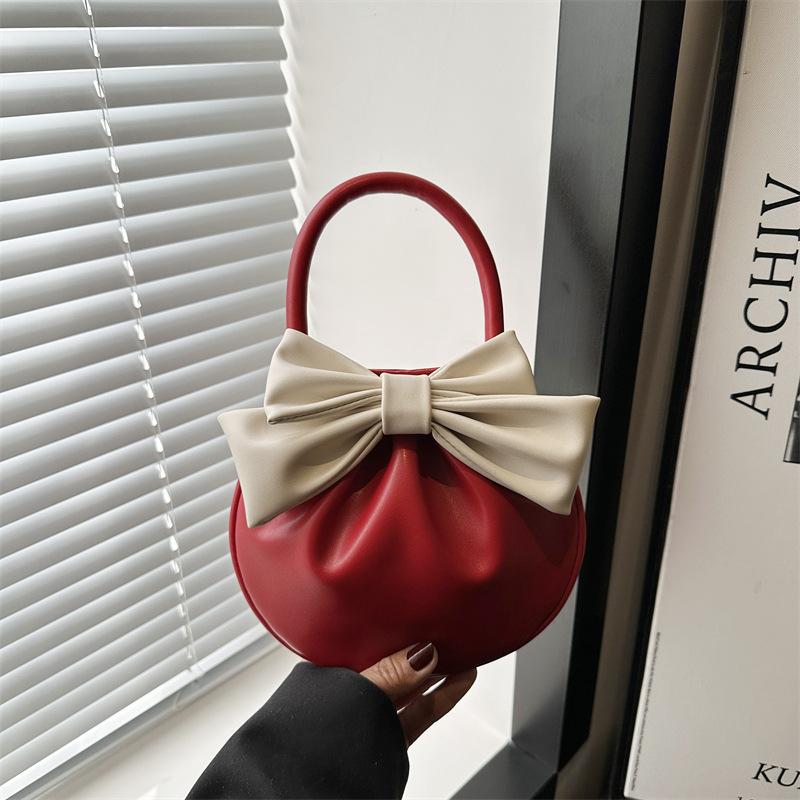 Niche design bow handbag new sense contrasting color small round bag fashionable versatile high value women