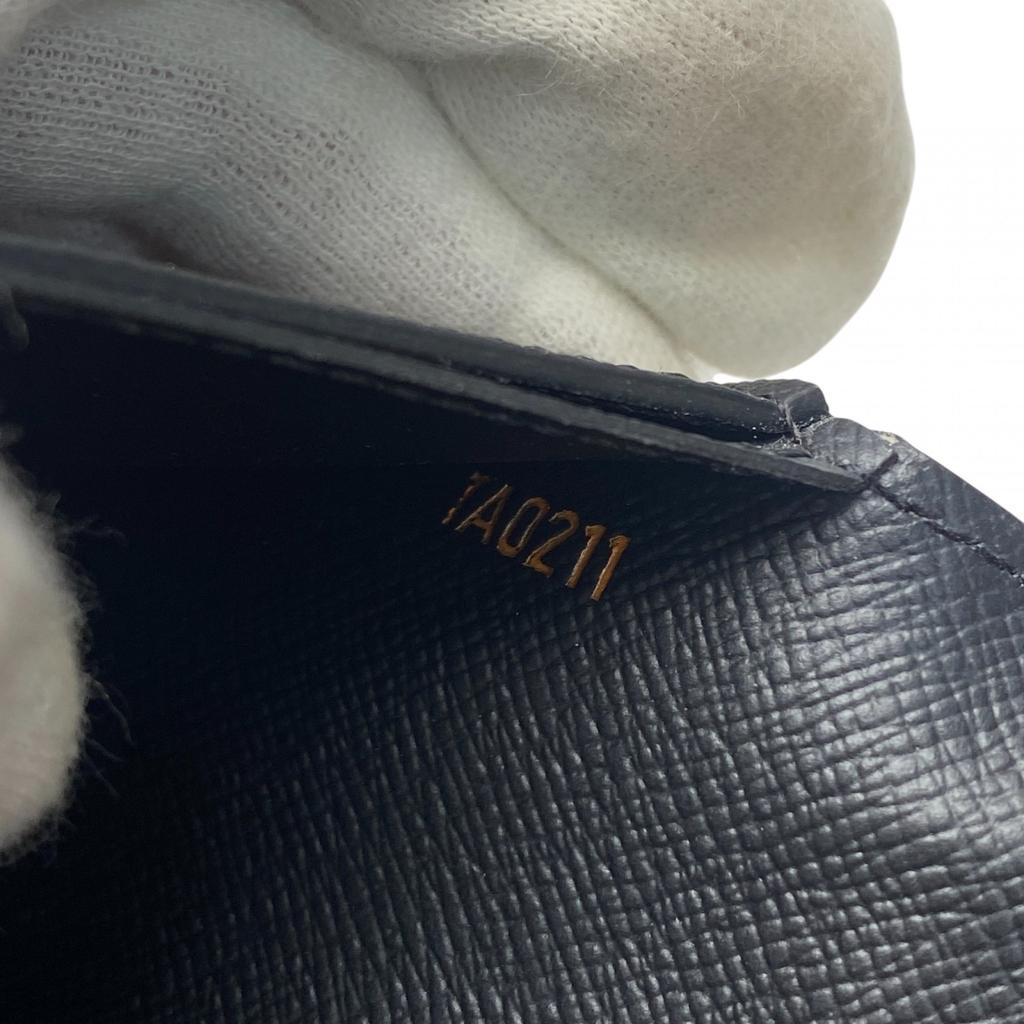 Używany portfel LOUIS VUITTON Seria Brązowo/Pomarańczowa PVC męski