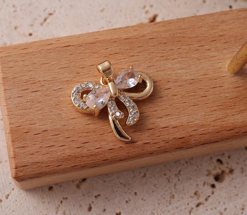 

Two-Tone Gold & Silver Diamond Bow Hair & Necklace Ornaments - Small DIY Pendants for Clothing & Accessories.