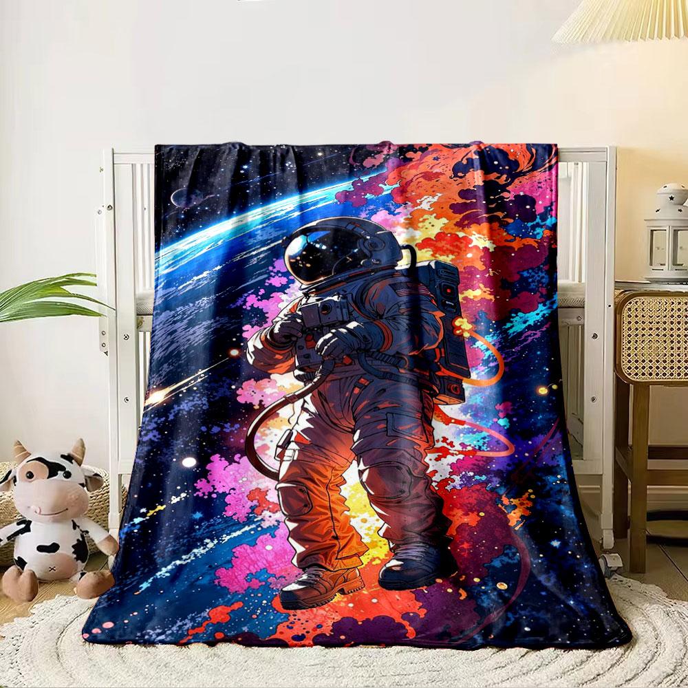 An astronaut floating in space with colorful cosmic explosions behind. for all seasons blanket lunch break throw gift 80cm x 120cm