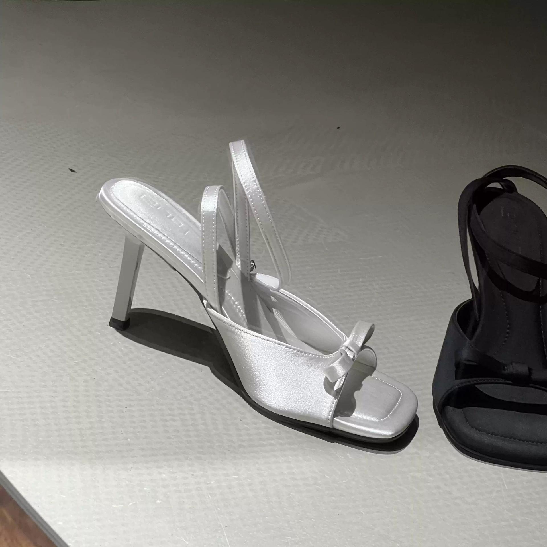 

Fish mouth open-toed black bow slippers women s 2025 summer new one-word strap sandals stiletto high heels outer wear 35