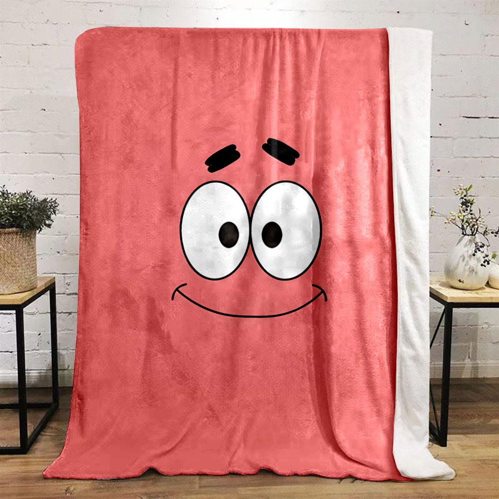 A simple pink background with a smiling cartoon face and wide eyes. for all seasons blanket lunch break throw gift