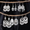 Bohemian Ethnic Miao Silver Tassel Earrings with Butterfly, Peacock, and Flower Design for Women – Long Dangle Jewelry for Travel Photos.