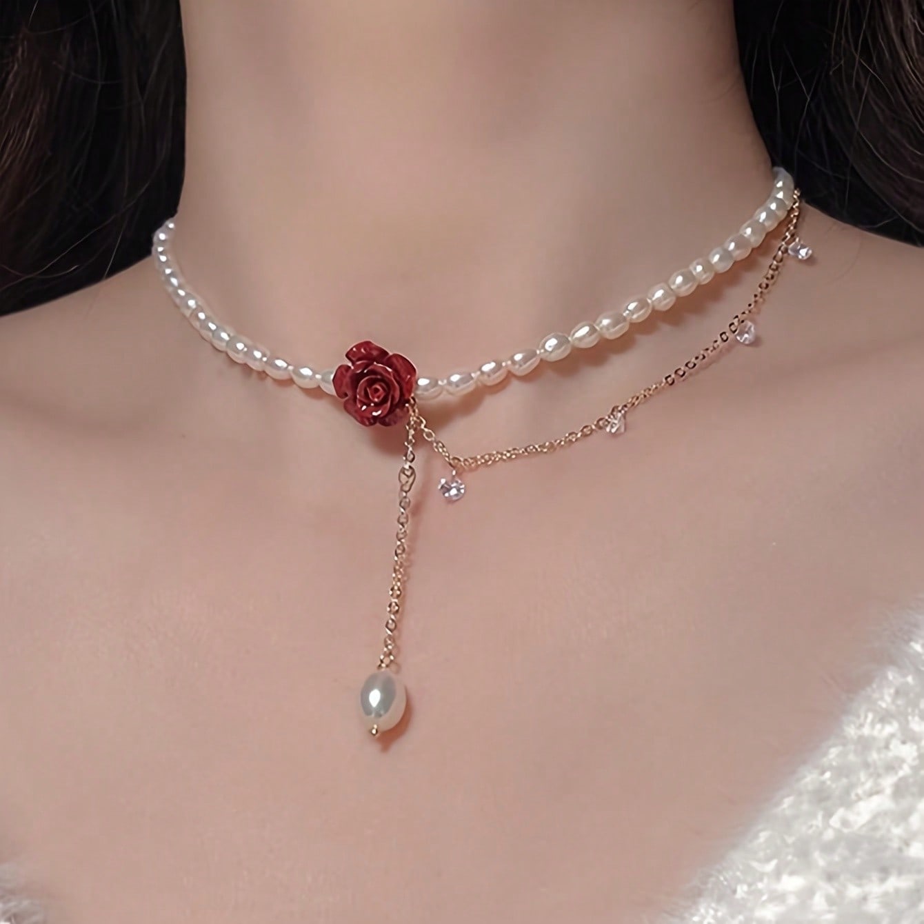 

A red rose faux pearl necklace with a gold chain, perfect for parties, weddings, and as a Valentine s Day gift.