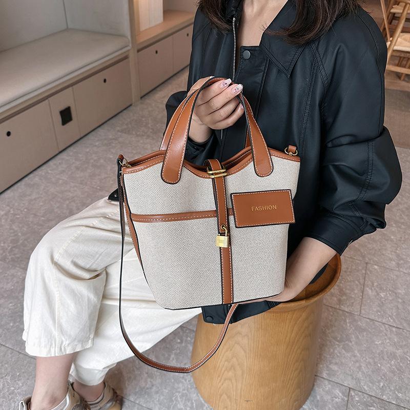 Canvas niche contrasting color handbag women's 2025 summer new Korean fashion shoulder messenger bag versatile bucket bag