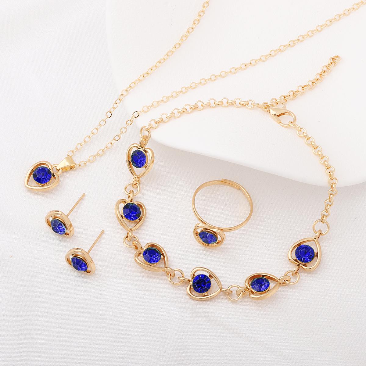 

Crystal Heart Jewelry Set (Peach Heart Necklace, Earrings, Ring, Bracelet) One Size синій