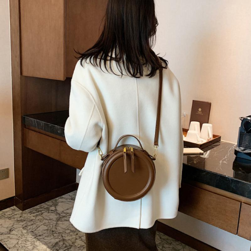 Jednobarevná crossbody kabelka pro ženy kulatá malá kabelka Módní návrhářské tašky PU kožená taška přes rameno Dámské peněženky na zip
