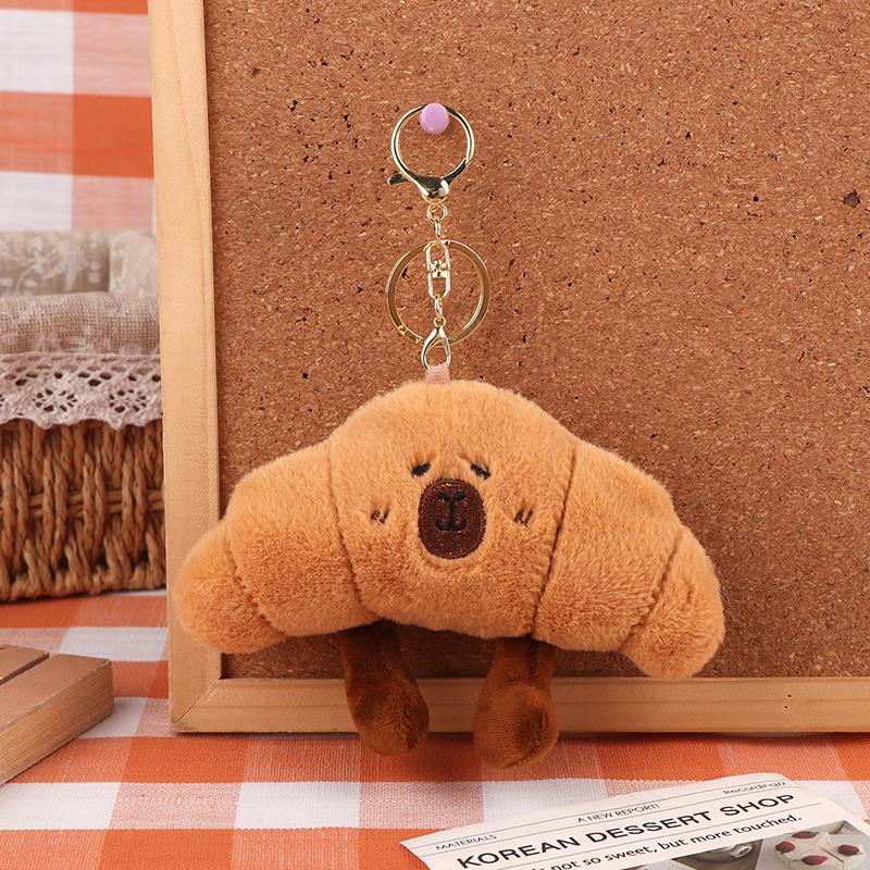 

Плюшевая игрушка Капибара в виде хлеба, брелок, мультяшный круассан Капибара, мягкая набивная кукла, подвеска, кольцо для ключей, декор для рюкзака, подарок для ребенка