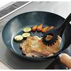 This 24cm iron skillet with a plain wood handle is made in Japan and is suitable for induction cooktops. It's lightweight and requires no seasoning. P