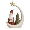 Resin Christmas Figure With Santa Holding Gift by Tree, Moon and Star Shelf Ornament for a Seasonal Home Arrangement With Cream and Red Features