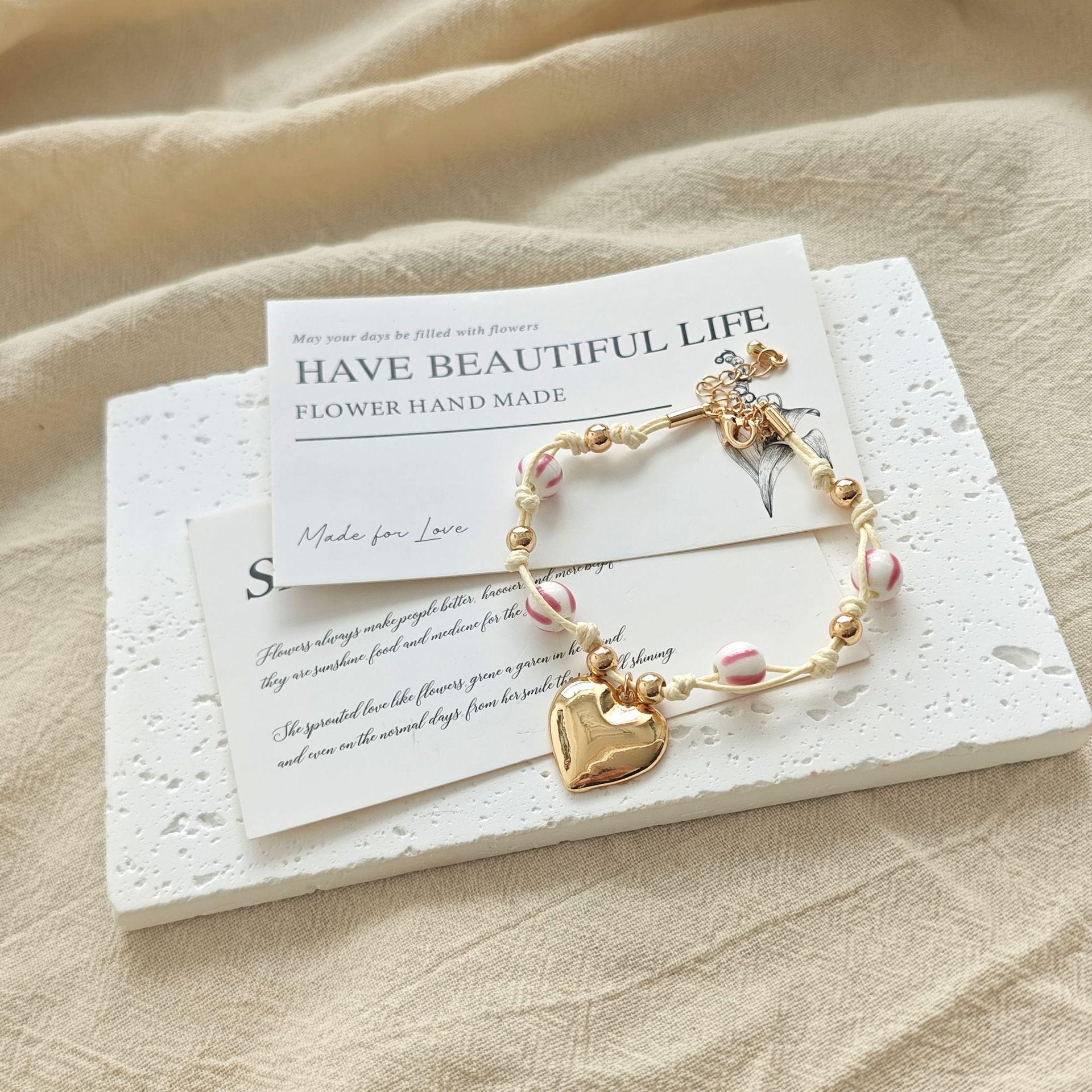 White Cord Heart Pendant Bracelet with Pink Ceramic Beads: Sweet, Playful, and Girlish Style Hand Accessory. розовый