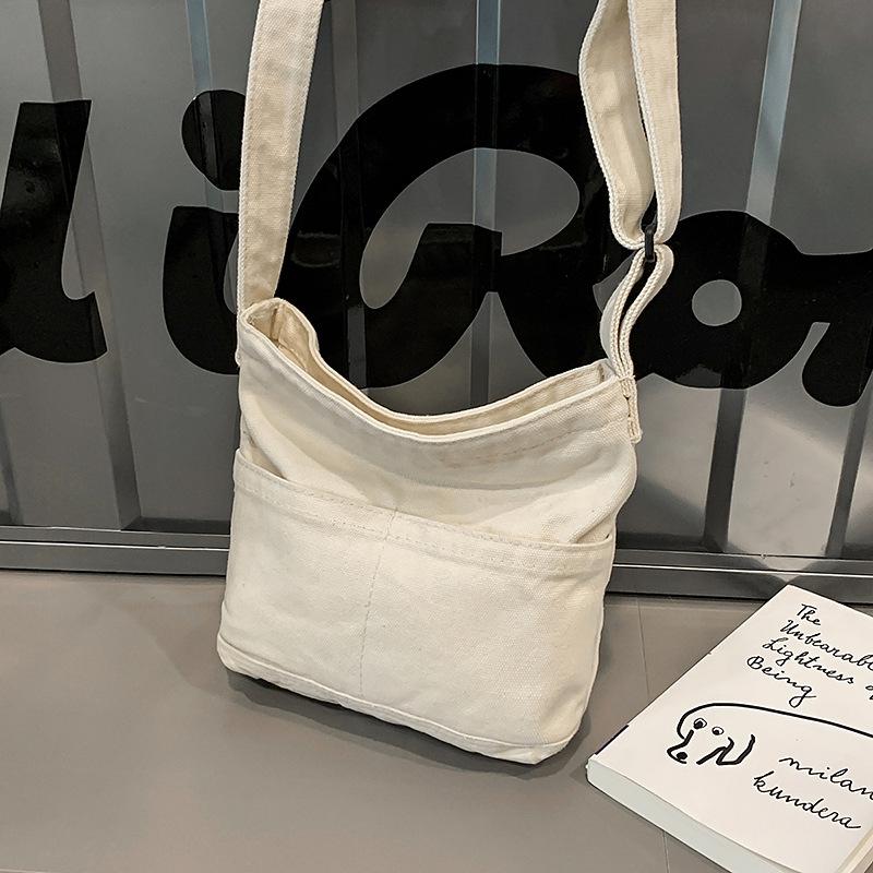 

Japanese casual canvas bag 2026 new simple small fresh shoulder bag niche design messenger bag small mobile phone bag