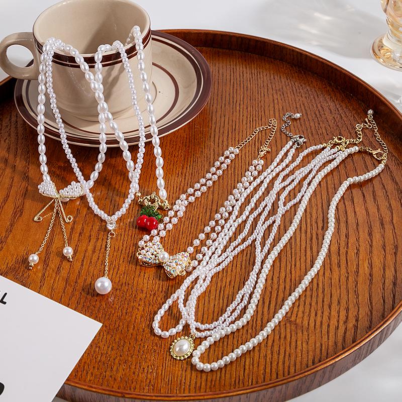 

Elegant Double Layer Pearl & Tassel Sweater Chain with Bow Pendant