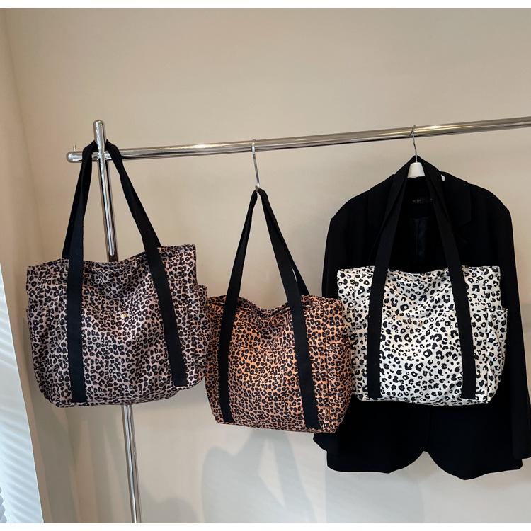 Leopard Print Canvas Tote: Large Capacity Autumn Shoulder Bag for Women, Versatile for College and Commute.