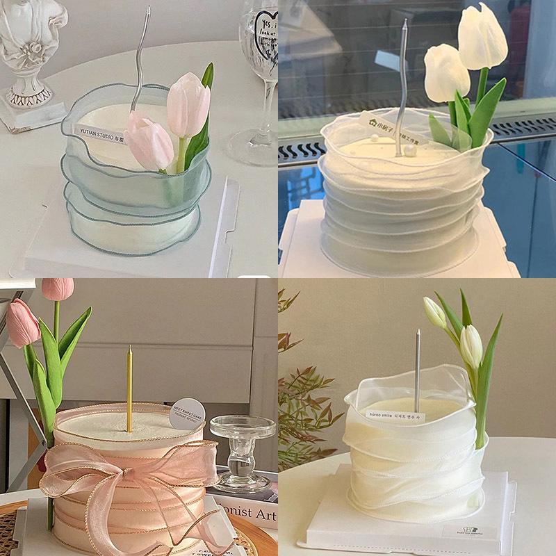 Minimalistischer Tulpen-Kuchenaufsatz mit frischen Blumen und Band für den Muttertag oder Geburtstag