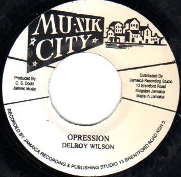 7inch Record DELROY WILSON - Opression / Help Me Pick Up The Pie NONE Mu-Zik City Rec 2013 Jamaica Reggae, Ska & Dub Used