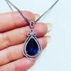 Deep Blue Teardrop Pendant Necklace with Double Sparkling Halo and Bow Accent Elegant Royal Inspired Jewelry for Women
