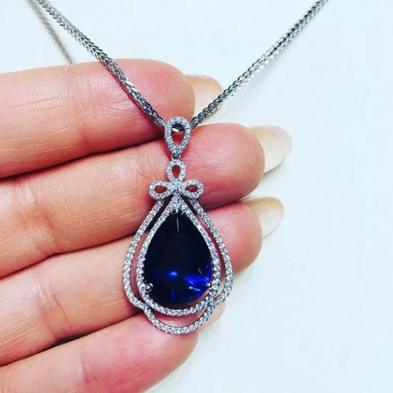 Deep Blue Teardrop Pendant Necklace with Double Sparkling Halo and Bow Accent Elegant Royal Inspired Jewelry for Women