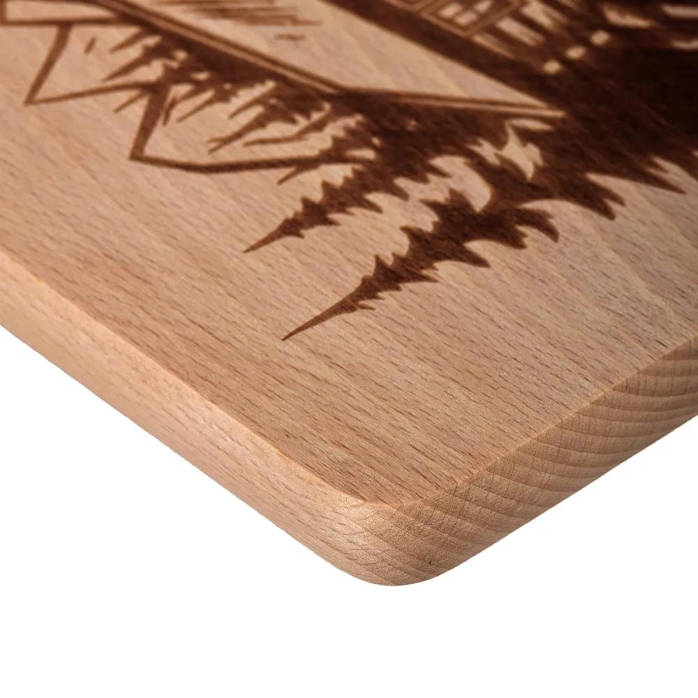 Wooden chopping board with an engraved mountain cottage