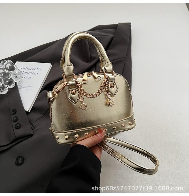 2025 new niche design high-end champagne rivet portable shell bag women's fashionable foreign style shoulder messenger bag