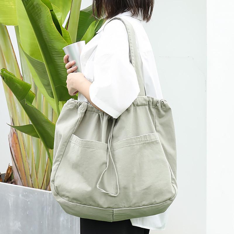 IELGY Japanese casual drawstring bundle handbag, retro washed canvas fashionable solid color shoulder women's bag