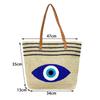 Umweltfreundliche Stroh-Schultertasche mit blauem Augen-Stickdesign für Sommerausflüge