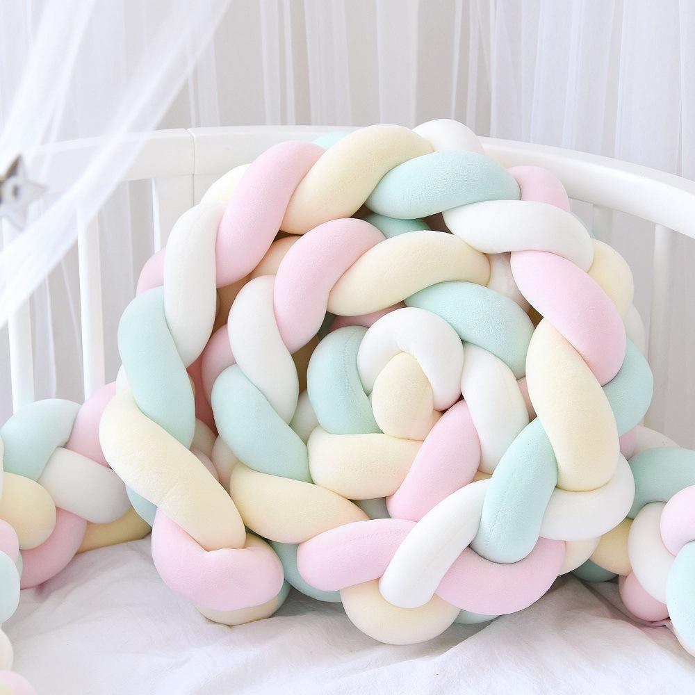 Three-strand knitted crib bumper, cable knit crib bumper