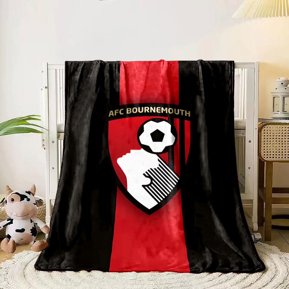 A shield with a soccer player heading a ball and vertical red stripes. for all seasons blanket lunch break throw gift