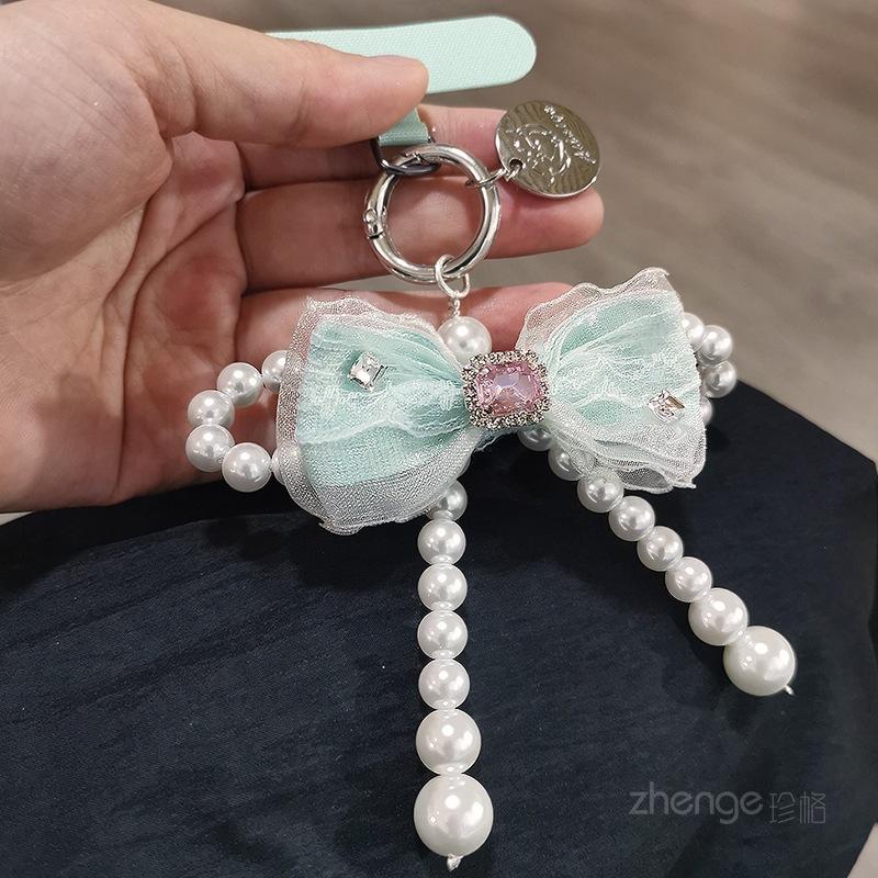 

Mesh bow pearl bracelet women s ins fashion Xiaoxiangfeng mobile phone pendant mobile phone lanyard short wrist [green] mesh bow pearl pendant + green card strip