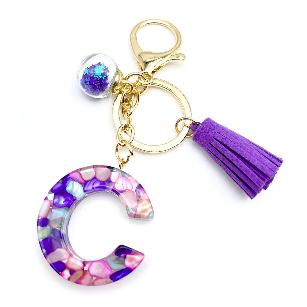 Europäischer und Amerikanischer Bestseller Englischer Initialschlüsselanhänger mit Lila Quasten-Accessoire