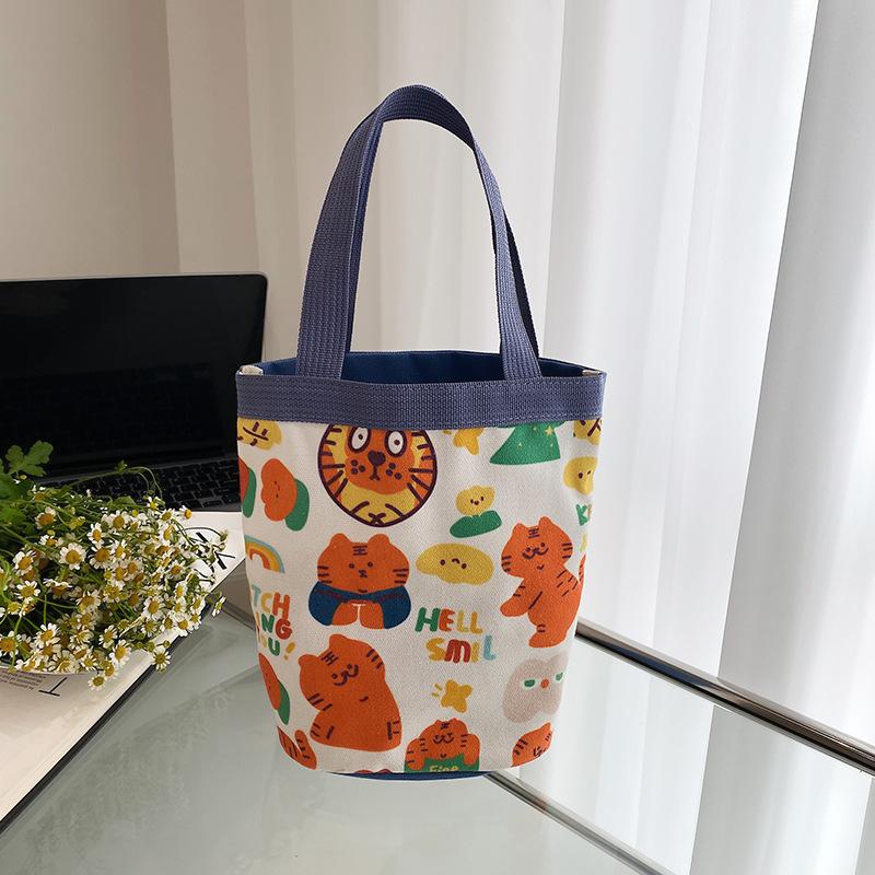 

Spring new ins cute cartoon tiger print, bucket bag, portable canvas bag, girl s heart round bucket bento bag синій